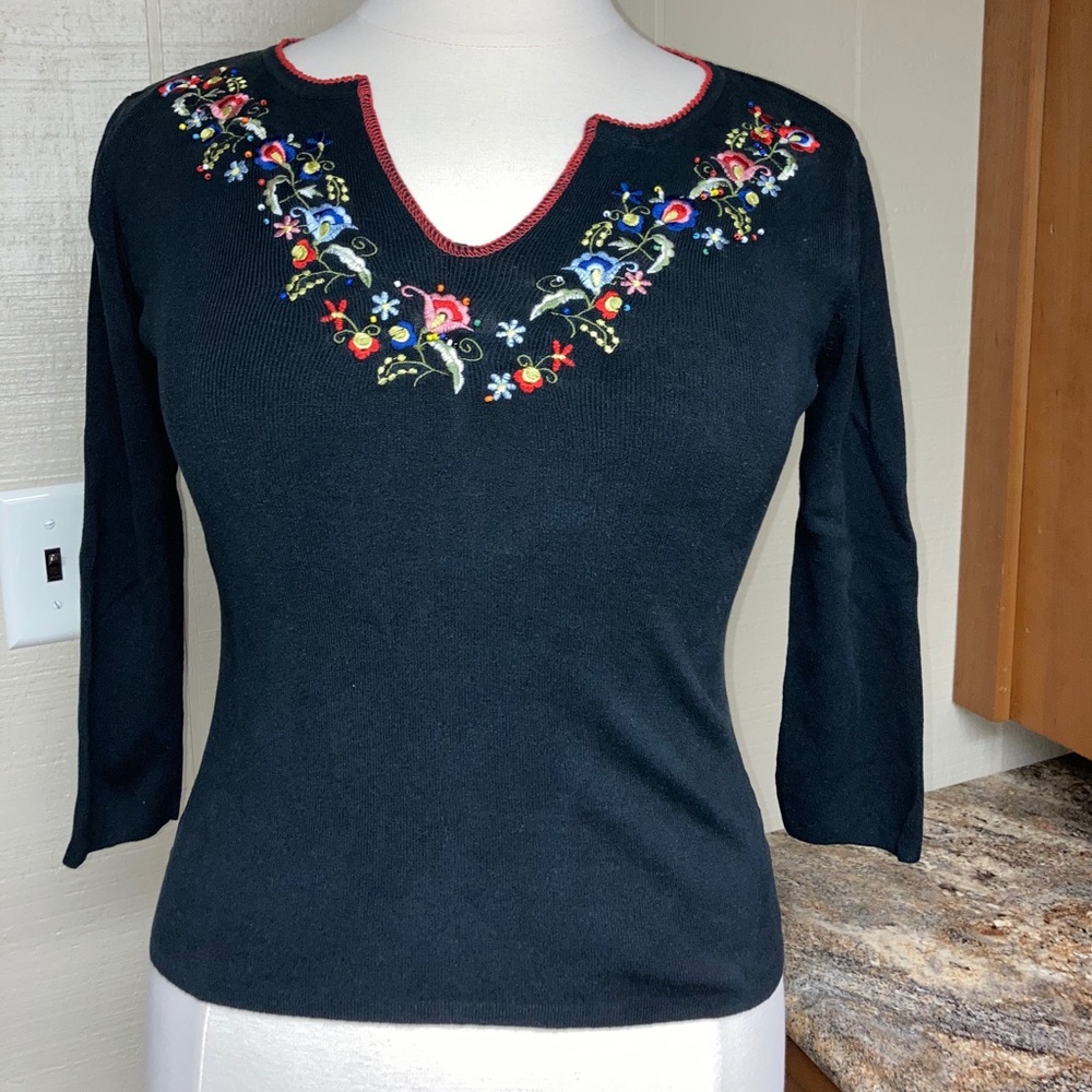 Black knit embroidered top.